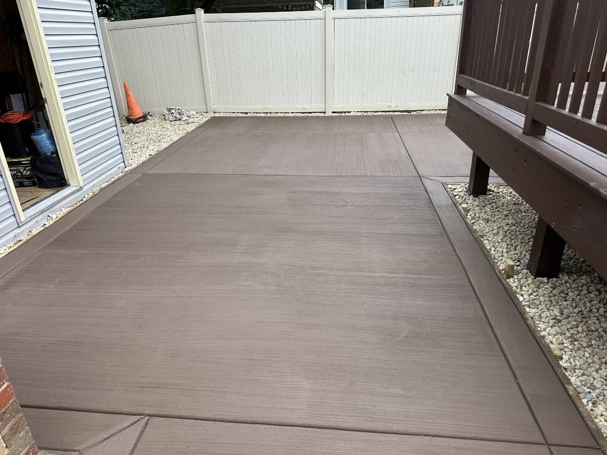 Concrete patio poured alongside a wood deck
