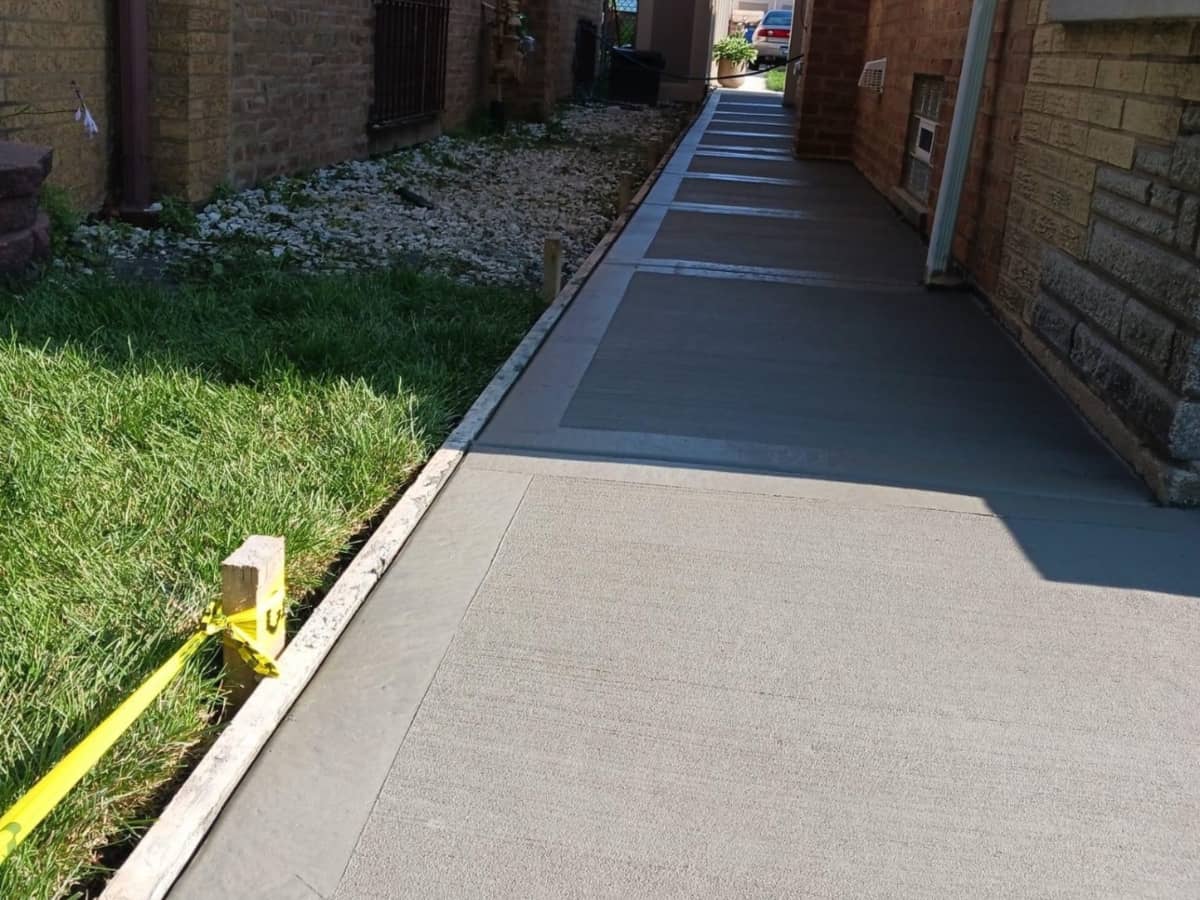 Smooth concrete walkway alongside a house